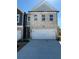 New construction home showcasing a two-car garage and light brick facade with complementary gray trim and matching roof at 5649 Hislop Ln # 90, Mableton, GA 30126