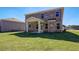 Expansive backyard showcasing a covered patio and well-maintained lawn area, great for activities at 136 Dalston Cv, Stockbridge, GA 30281