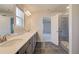 Bright bathroom with double vanity, tile flooring, and shower visible from doorway for open feel at 136 Dalston Cv, Stockbridge, GA 30281