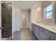 Stylish bathroom featuring a tiled shower, double vanity, and tile floor for a modern look at 136 Dalston Cv, Stockbridge, GA 30281