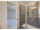 Bathroom with tiled shower and glass door, viewed from bedroom, showcasing the open layout at 136 Dalston Cv, Stockbridge, GA 30281