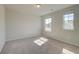 Neutral bedroom with carpet, light walls, two windows, and overhead lighting at 136 Dalston Cv, Stockbridge, GA 30281