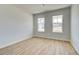 Bright bedroom with hardwood floors and two windows offering natural light and neighborhood views at 136 Dalston Cv, Stockbridge, GA 30281