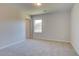 Bright bedroom features neutral walls, plush carpeting, and a window letting in natural light at 136 Dalston Cv, Stockbridge, GA 30281