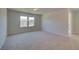 Spacious bedroom with carpet, natural light from two windows, and attached bath and closet at 136 Dalston Cv, Stockbridge, GA 30281
