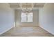 Elegant dining room with a modern chandelier and coffered ceiling, perfect for entertaining at 136 Dalston Cv, Stockbridge, GA 30281