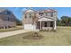 Lovely two-story home featuring a brick exterior, attached garage, and pristine front yard at 136 Dalston Cv, Stockbridge, GA 30281