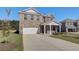 Beautiful brick home with an attached garage, a well-maintained lawn, and a welcoming front porch at 136 Dalston Cv, Stockbridge, GA 30281