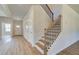 Inviting hallway with wood floors, a staircase, and convenient closet space at 136 Dalston Cv, Stockbridge, GA 30281