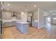 Modern kitchen featuring a large island, stainless steel appliances, and stylish gray cabinetry at 136 Dalston Cv, Stockbridge, GA 30281