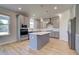 Bright kitchen featuring stainless steel appliances, gray cabinets, a center island, and natural light at 136 Dalston Cv, Stockbridge, GA 30281