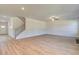 Spacious living room with hardwood floors, a staircase, and ample natural light at 136 Dalston Cv, Stockbridge, GA 30281