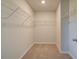 Walk-in closet with carpet, wire shelves, and ample storage space for organizing clothes at 136 Dalston Cv, Stockbridge, GA 30281