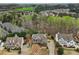 Aerial view of a two-story home with a neutral paint job in a treed neighborhood at 1870 Marcia Overlook Dr, Cumming, GA 30041