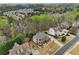 Aerial view of a neighborhood with tree coverage, and a two-story home with neutral paint at 1870 Marcia Overlook Dr, Cumming, GA 30041