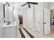 Bathroom featuring double doors, walk-in closet, and white cabinets at 1870 Marcia Overlook Dr, Cumming, GA 30041