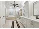 Bright bathroom featuring double vanity, tub, and glass shower, offering a spa-like retreat at 1870 Marcia Overlook Dr, Cumming, GA 30041