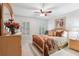 Cozy bedroom with wood furniture, complemented by plantation shutters, and neutral paint at 1870 Marcia Overlook Dr, Cumming, GA 30041
