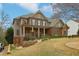 Two-story brick home with a covered front porch and well-manicured lawn at 1870 Marcia Overlook Dr, Cumming, GA 30041