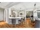 An open kitchen with an island and seating. An adjacent sitting and dining area are also shown at 1870 Marcia Overlook Dr, Cumming, GA 30041