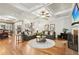 Spacious living room features hardwood floors, coffered ceiling, fireplace, and ample natural light at 1870 Marcia Overlook Dr, Cumming, GA 30041