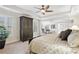 Comfortable main bedroom with closet, large bed, carpet floors, and large windows at 1870 Marcia Overlook Dr, Cumming, GA 30041