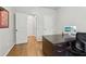 Home office with hardwood floors, a view of the back yard, neutral paint, and two closets at 1870 Marcia Overlook Dr, Cumming, GA 30041