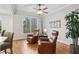 Cozy sitting area with natural light, hardwood floors, and comfortable leather chairs at 1870 Marcia Overlook Dr, Cumming, GA 30041