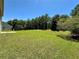 The spacious backyard offers ample green space framed by mature trees, ideal for outdoor activities at 234 Silver Arrow Cir, Austell, GA 30168