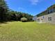 The expansive backyard of this home is enhanced by the surrounding trees for an inviting atmosphere at 234 Silver Arrow Cir, Austell, GA 30168