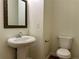 Convenient powder room featuring a pedestal sink and a modern toilet at 234 Silver Arrow Cir, Austell, GA 30168