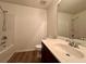 This bathroom features a combination tub and shower, vanity with sink, and wood look flooring at 234 Silver Arrow Cir, Austell, GA 30168
