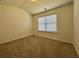 This is a cozy bedroom featuring neutral carpeting and a window that provides ample natural light at 234 Silver Arrow Cir, Austell, GA 30168