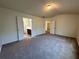 Spacious bedroom with neutral carpet, complemented by doors leading to the bathroom and hallway at 234 Silver Arrow Cir, Austell, GA 30168
