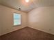 This is a cozy bedroom featuring neutral carpeting and a window that provides ample natural light at 234 Silver Arrow Cir, Austell, GA 30168