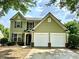 Charming two-story home with a well-maintained lawn, two-car garage, and verdant surroundings at 234 Silver Arrow Cir, Austell, GA 30168