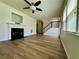 Inviting living room with wood-look flooring, a fireplace, and stairs leading to the upper level at 234 Silver Arrow Cir, Austell, GA 30168