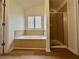Elegant bathroom with a soaking tub, separate shower, and wood-look flooring at 234 Silver Arrow Cir, Austell, GA 30168