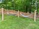 Large backyard featuring two rope hammocks and a wood fence with trees in the background at 2772 Hillgrove Dr, Dacula, GA 30019