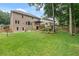 Expansive backyard with manicured lawn, mature trees, and a deck for outdoor enjoyment at 2772 Hillgrove Dr, Dacula, GA 30019
