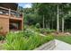Landscaped backyard with a deck and stairs, perfect for outdoor living and entertaining at 2772 Hillgrove Dr, Dacula, GA 30019