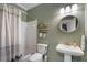 Bathroom featuring a shower/tub combo, single sink, decorative mirror and an earth tone paint color at 2772 Hillgrove Dr, Dacula, GA 30019