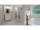 Serene bathroom featuring a glass shower, freestanding tub, a modern vanity, and natural light at 2772 Hillgrove Dr, Dacula, GA 30019