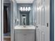 Well-lit bathroom with modern fixtures and a blue accent wall at 2772 Hillgrove Dr, Dacula, GA 30019