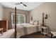 A well-lit bedroom features a four-poster bed, neutral walls, and window with verdant views at 2772 Hillgrove Dr, Dacula, GA 30019