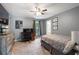 Spacious bedroom featuring neutral carpet, ceiling fan, and TV at 2772 Hillgrove Dr, Dacula, GA 30019