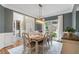 Cozy dining room with hardwood floors, modern lighting, and views into the entryway and butler's pantry at 2772 Hillgrove Dr, Dacula, GA 30019