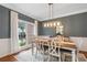 Bright dining room with a large window, stylish lighting, and a classic dining set at 2772 Hillgrove Dr, Dacula, GA 30019