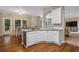 Open concept kitchen featuring white cabinetry and a seamless transition to the living and dining areas at 2772 Hillgrove Dr, Dacula, GA 30019
