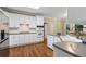 Modern kitchen with white cabinets, stainless steel appliances, and hardwood floors at 2772 Hillgrove Dr, Dacula, GA 30019